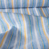 Vibrant Summer Beach Stripe linen fabric with chambray blues and summertime yellow stripes, ideal for fresh and classic summer garments.