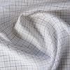 Rustic light check linen fabric with oatmeal and royal blue stripes on white background