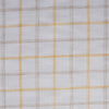 Creamy Lemon Oatmeal Check Linen Fabric, featuring sunshine yellow and earthy checks on white linen, with a fine weave for a soft feel and elegant drape.