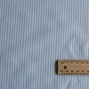 Light Blue & White Stripe Linen Blend Fabric with soft, pale blue and white vertical stripes, perfect for Summer garments like oversized shirts, dresses, tops, lightweight pants, and shorts. Slightly worn feel, may require lining due to pale color.