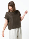 lady wearing linen top made using Ethel Designer Top sewing pattern by Style Arc, featuring a square shape, angled design lines, and wide facings, suitable for linen, crepe, silk, and light wool fabrics.