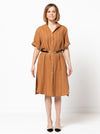 A sophisticated short-sleeved shirtmaker dress pattern featuring a collar stand, turn-back cuffs, and a shaped hemline, suitable for linen and other fabrics.