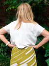 Stylish Rona Wrap Skirt sewing pattern with full faux wrap, calf-length cut, and front tie waist, suitable for rayon, crepe, silk, or washed linen fabrics.