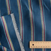 Bondi Beach Stripe linen fabric with vibrant stripes in deep blue, yellow, white, red, and light blue.