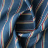 Bondi Beach Stripe linen fabric with vibrant stripes in deep blue, yellow, white, red, and light blue.