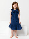 A child wearing dress made using Bonnie Kids Dress Sewing Pattern - A-line swing dress with frill hem and sleeves, Peter Pan collar, for kids ages 2-14, suitable for woven fabrics like linen, cotton, and rayon