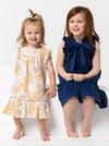 two kids wearing dress made using Bonnie Kids Dress Sewing Pattern - A-line swing dress with frill hem and sleeves, Peter Pan collar, for kids ages 2-14, suitable for woven fabrics like linen, cotton, and rayon