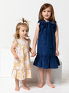 two kids wearing dress made using Bonnie Kids Dress Sewing Pattern - A-line swing dress with frill hem and sleeves, Peter Pan collar, for kids ages 2-14, suitable for woven fabrics like linen, cotton, and rayon