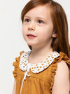 A child wearing dress made using Bonnie Kids Dress Sewing Pattern - A-line swing dress with frill hem and sleeves, Peter Pan collar, for kids ages 2-14, suitable for woven fabrics like linen, cotton, and rayon