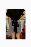 Lady wearing blach ginghamshortsmade of Bottlebrush Pants and Shorts Sewing Pattern - High-Waisted Flared Pants and Mini Shorts