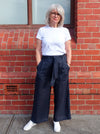 Clare Pant Sewing Pattern with wide leg, elastic waist, tie belt, angled pockets, and front pleats, perfect for fabrics like linen, crepe, or fine wool