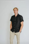 a man weariing black colour shirt made using Finch Men's Shirt Sewing Pattern - Button-Up Shirt with Scoop Back Hem