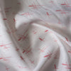 Sheer white 100% linen fabric with delicate red crosshatch print and a loose, elegant weave