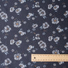 Dark navy 100% linen fabric with white daisy floral pattern, light-blue and ochre details, suitable for summer clothing