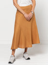 Haven Woven Skirt Sewing Pattern - mid-length skirt with fitted waist, invisible zip, flared hem with curved seams, and shaped waistband.