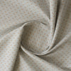 Honeydew Petals linen-cotton blend fabric with mustard floral print on a greyish-white base.