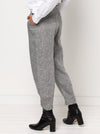 Kew Woven Pant sewing pattern, featuring a waisted, fly front design with a shaped leg, unique hem, and angled pockets, suitable for linen, fine wool, or crepe fabrics.