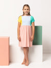 Lacey Kids Dress sewing pattern, featuring an easy slip-on design with extended shoulders, square line bodice, and slightly gathered skirt, suitable for knit or woven fabrics.