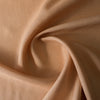 Nutmeg-colored 100% linen fabric with a fine, close weave, smooth finish, and soft drape, suitable for various dressmaking applications.