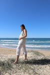 Pipit Vest Sewing Pattern - Reversible Oversized Vest in Two Lengths. made with natural linen fabric. Pregnant woman wearing pipit vest made of natural colour linen fabric in the beach side