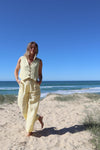 Pipit Vest Sewing Pattern - Reversible Oversized Vest in Two Lengths. Image of A woman wearing pipit vest made oflinen fabric in the beach side 