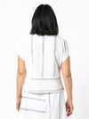 Quinn Woven Top sewing pattern with square cut, extended shoulder line, boxy shape, and front and back panelling.