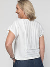 Quinn Woven Top sewing pattern with square cut, extended shoulder line, boxy shape, and front and back panelling.