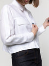 lady wearing white jacket made using Smith Woven Jacket with buttoned fly front, square shape, full-length sleeves with tabs, front pockets, and back pleat, made from linen fabric.