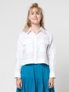 lady wearing white jacket made using Smith Woven Jacket with buttoned fly front, square shape, full-length sleeves with tabs, front pockets, and back pleat, made from linen fabric.