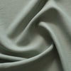 Soft Moss 100% Linen Fabric with a fine close weave and subtle slubs, exuding a smooth touch and elegant drape