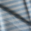 Alternating blue and white yarn-dyed stripes run along the Striped Sky 100% Linen Fabric, showcasing its lightweight, natural feel and soft texture