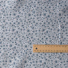 Teal Petal Dance linen fabric with teal floral print, dark orange dots, and grey background