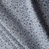 Teal Petal Dance linen fabric with teal floral print, dark orange dots, and grey background